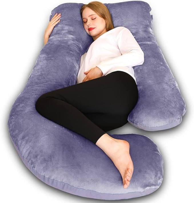 A woman using a pregnancy pillow