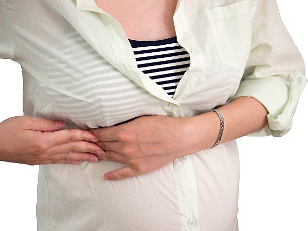 A woman having Rib Pain During Pregnancy’s Third Trimester