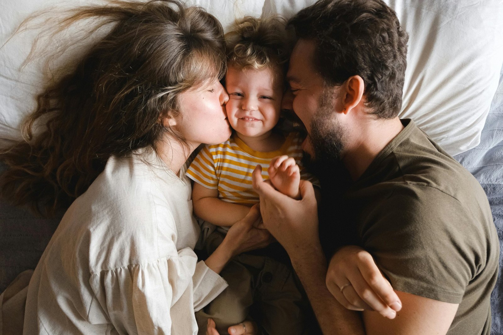 Gentle parenting vs Permissive parenting. Parents cuddling their child